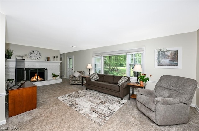 carpeted living room featuring a fireplace and baseboards