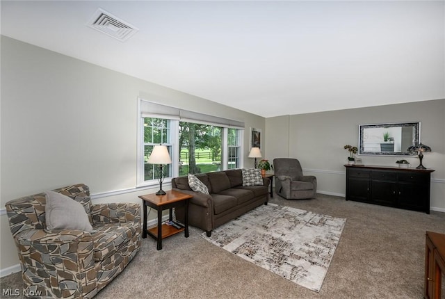 living area featuring visible vents, baseboards, and carpet floors