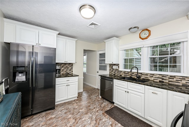 kitchen with white cabinets, stainless steel fridge, sink, backsplash, and dishwasher