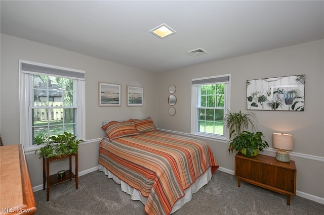 bedroom with dark colored carpet