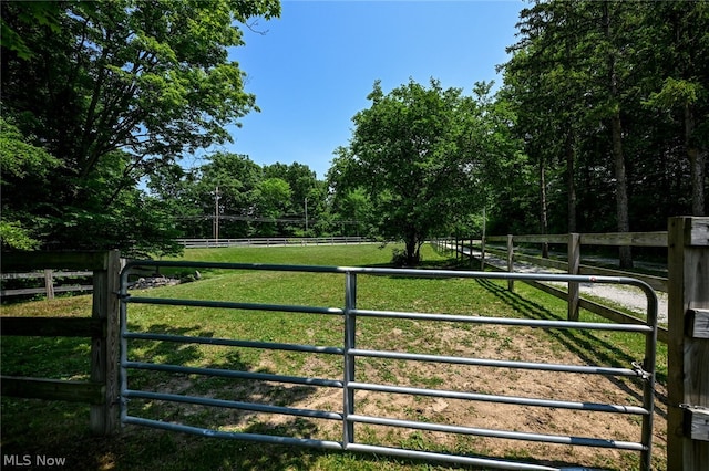 view of gate featuring a yard