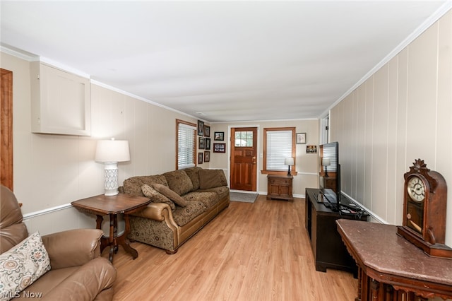 living room with crown molding and light hardwood / wood-style flooring