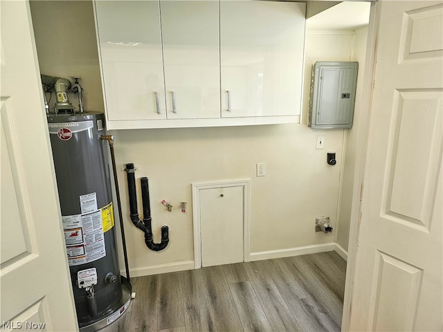 washroom with hardwood / wood-style floors, cabinets, electric panel, gas water heater, and hookup for an electric dryer