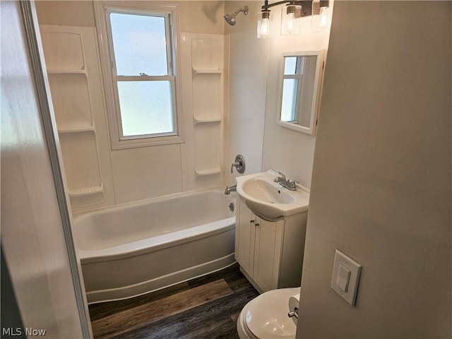 full bathroom with shower / bathing tub combination, vanity, wood-type flooring, and toilet