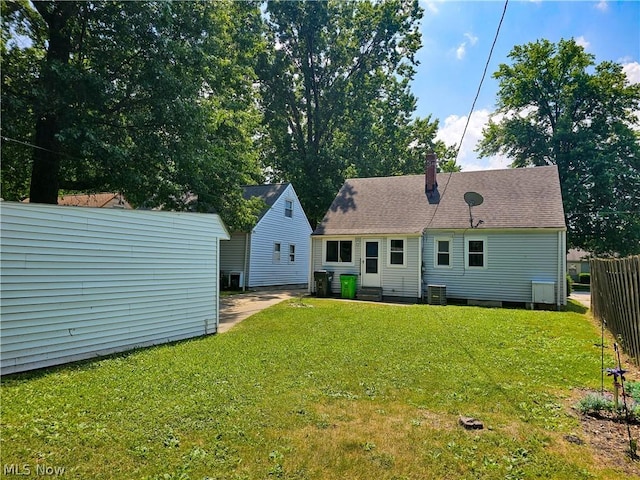 back of house with a lawn