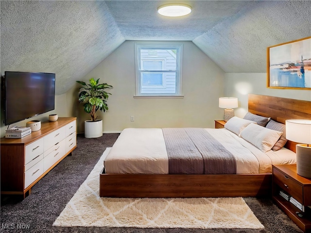 carpeted bedroom with a textured ceiling and vaulted ceiling