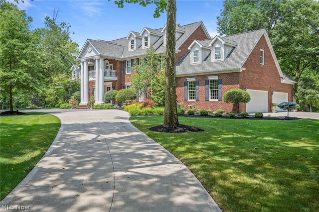 view of front of house with a front yard and a balcony