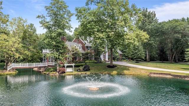 surrounding community featuring a yard and a water view