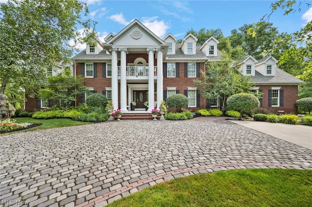 neoclassical home with a balcony