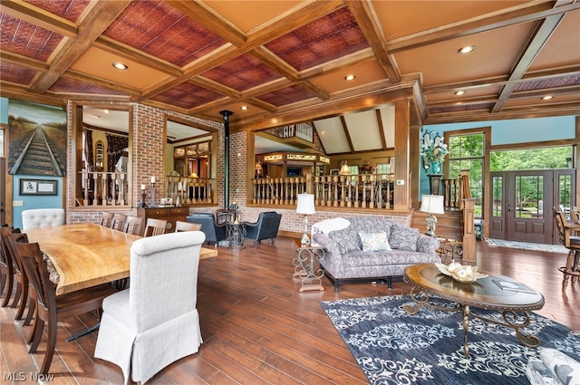 interior space featuring coffered ceiling, vaulted ceiling with beams, and hardwood / wood-style floors