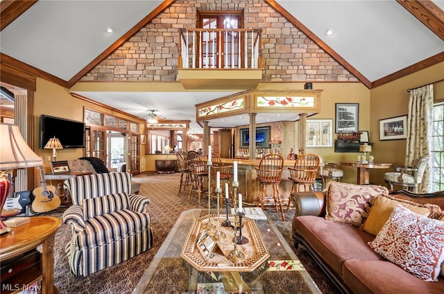 carpeted living room with high vaulted ceiling and ceiling fan