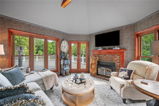 living room featuring a healthy amount of sunlight, french doors, carpet, and a brick fireplace