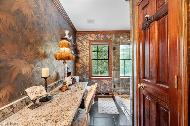 bathroom with an enclosed shower, ornamental molding, and tile floors