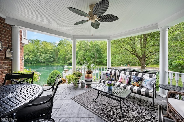 view of patio featuring a water view, an outdoor hangout area, and ceiling fan