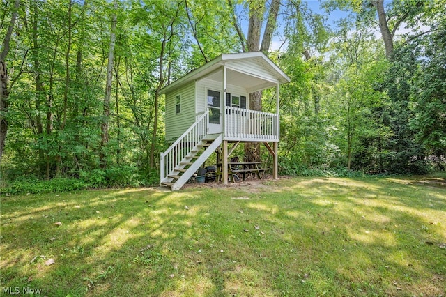 rear view of property featuring a yard