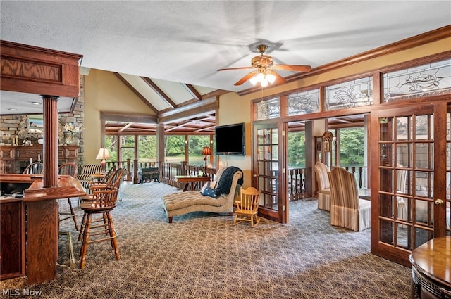 interior space featuring a wealth of natural light, lofted ceiling with beams, ceiling fan, and a textured ceiling