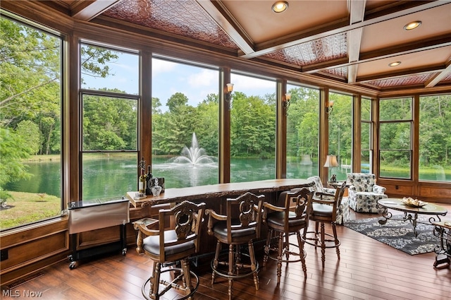 sunroom with beamed ceiling, a healthy amount of sunlight, and coffered ceiling