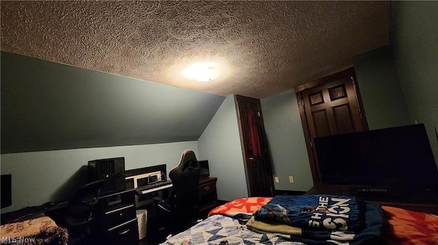 bedroom featuring lofted ceiling and a textured ceiling