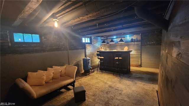 basement featuring indoor bar and carpet flooring