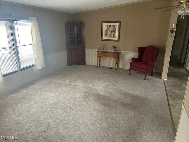 unfurnished room with ceiling fan, crown molding, carpet floors, and a textured ceiling