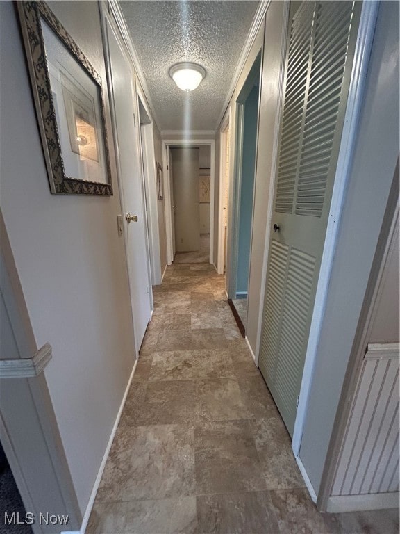 corridor featuring a textured ceiling