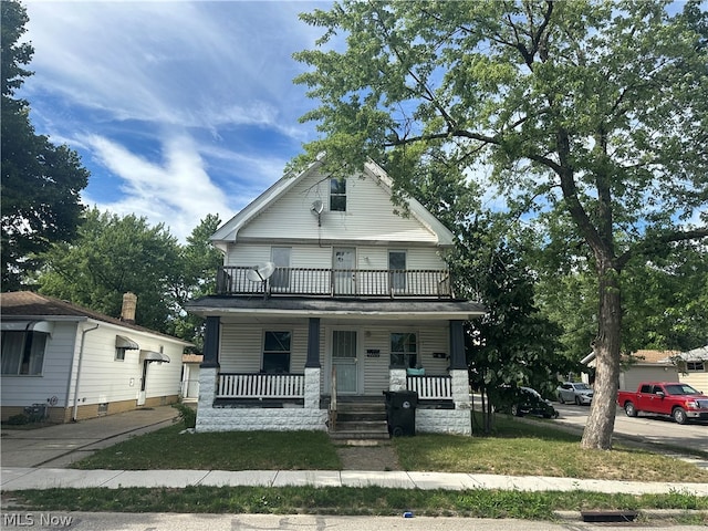 view of front facade with a balcony and covered porch