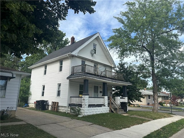 view of front of home featuring a balcony and covered porch