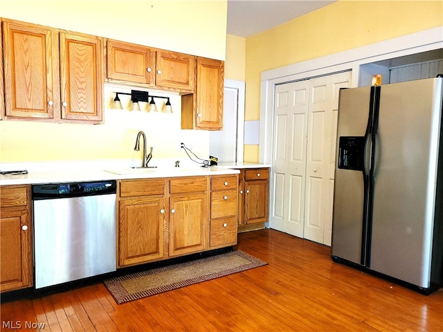 kitchen featuring dark wood-type flooring, appliances with stainless steel finishes, and sink