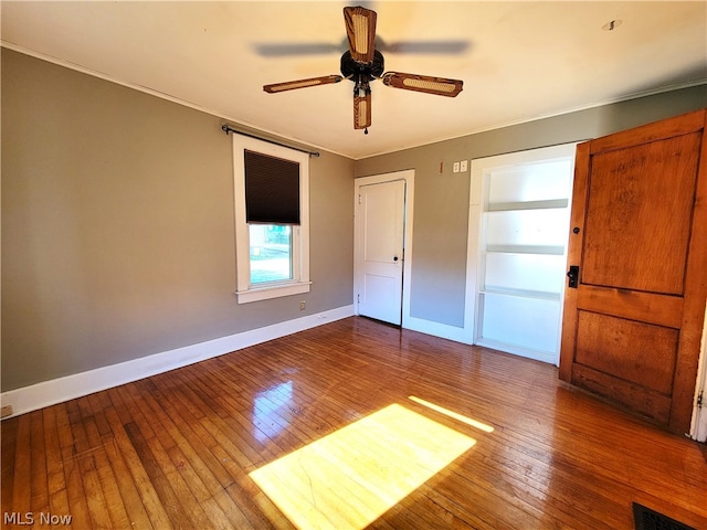 unfurnished bedroom with dark wood-type flooring and ceiling fan