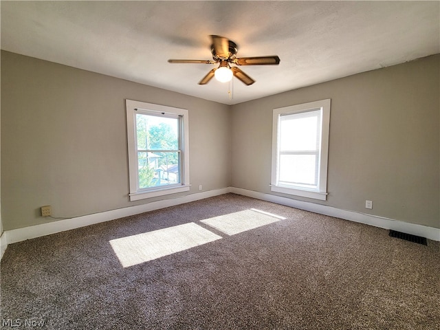 carpeted spare room with ceiling fan