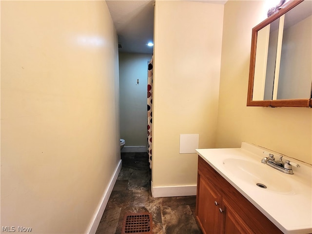 bathroom featuring tile flooring, toilet, and large vanity