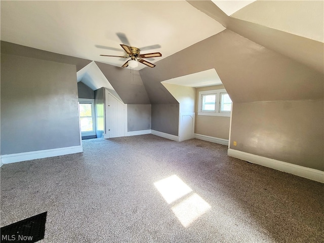 additional living space featuring ceiling fan, carpet floors, and lofted ceiling