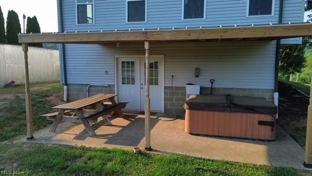 back of house featuring a patio and a hot tub