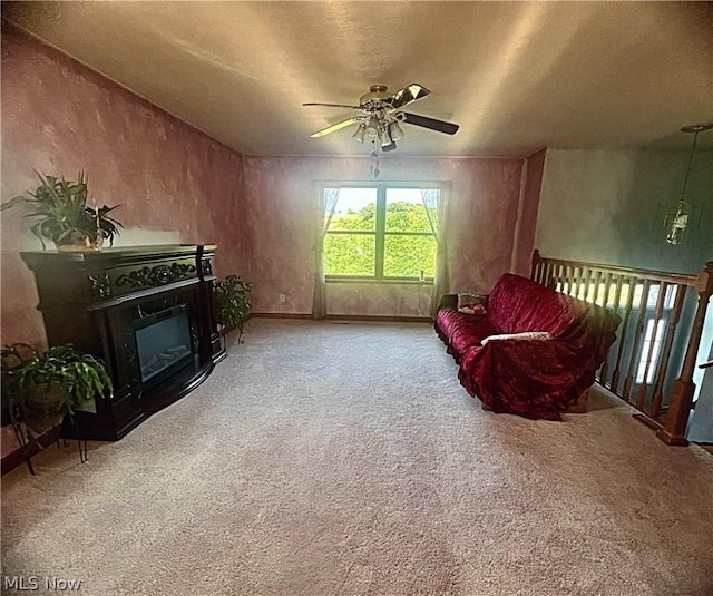 sitting room featuring carpet and ceiling fan