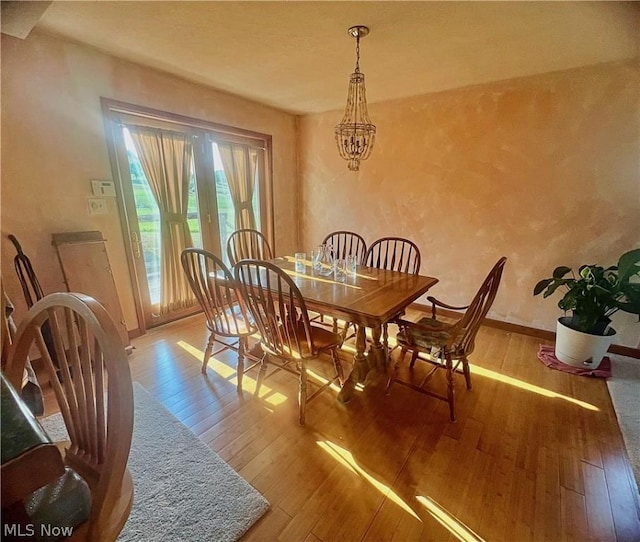 dining room with a chandelier and wood-type flooring