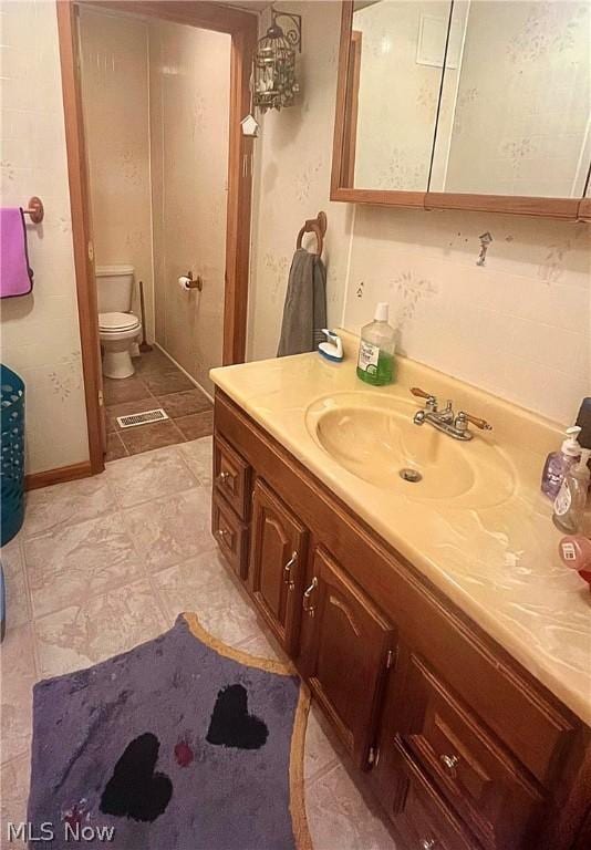 bathroom with vanity and toilet