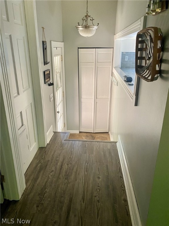 hallway with dark hardwood / wood-style flooring