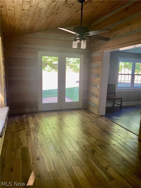 interior space featuring wooden ceiling, french doors, vaulted ceiling, ceiling fan, and dark hardwood / wood-style flooring