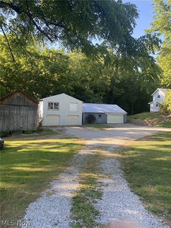 view of outbuilding featuring a garage and a lawn