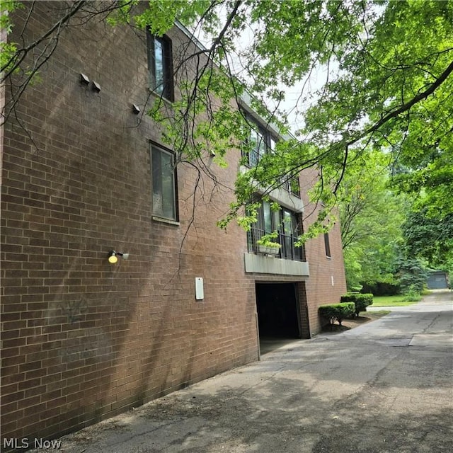 view of side of home with a balcony and a garage