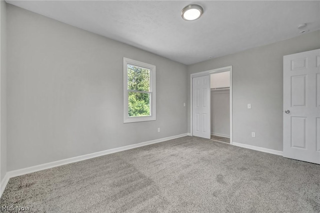 unfurnished bedroom with carpet and a closet