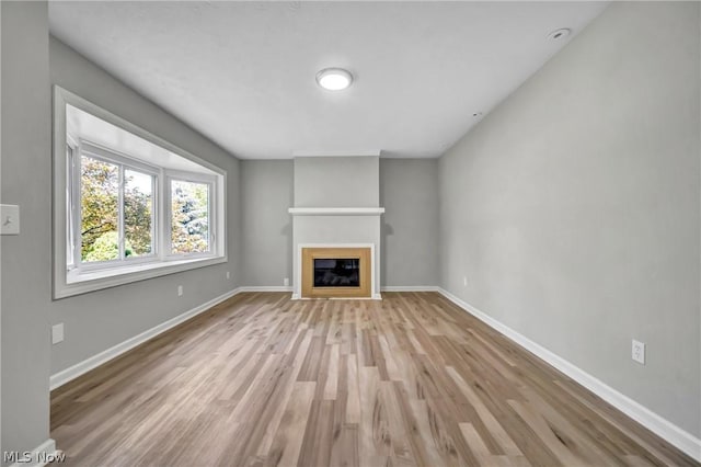 unfurnished living room featuring light wood-type flooring