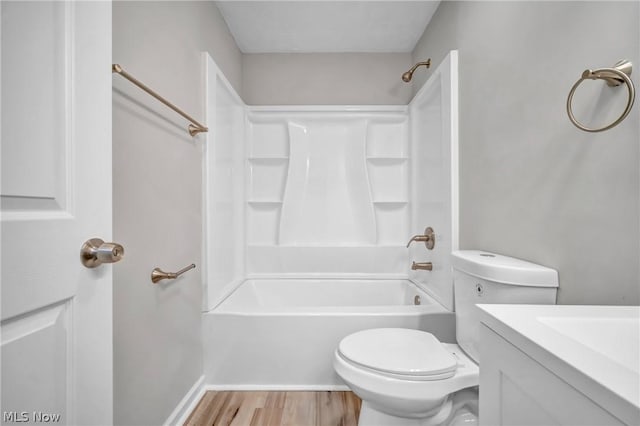 full bathroom featuring shower / bathing tub combination, hardwood / wood-style floors, vanity, and toilet