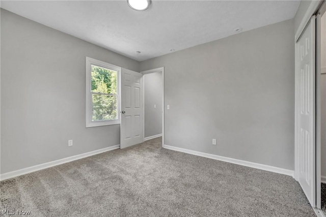 unfurnished bedroom with a closet and carpet