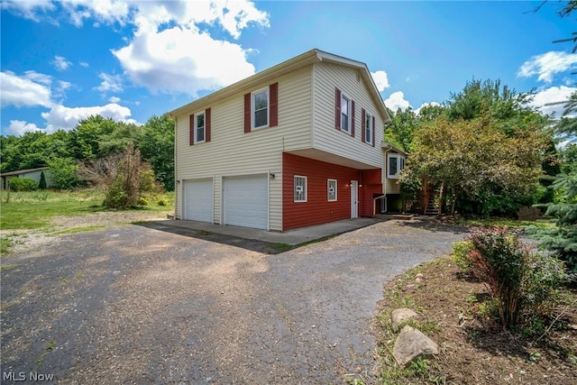 view of side of home featuring a garage