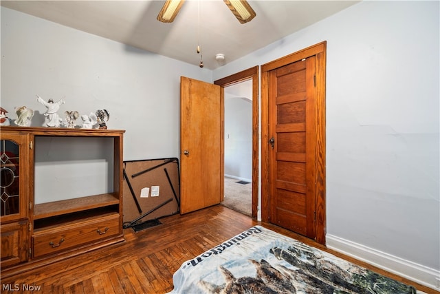 bedroom with ceiling fan and dark hardwood / wood-style floors