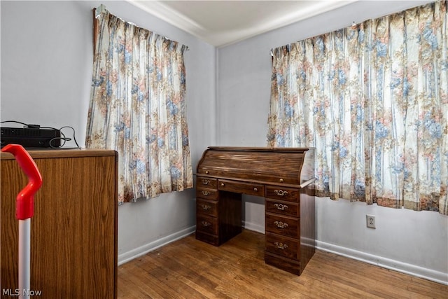 home office with hardwood / wood-style flooring