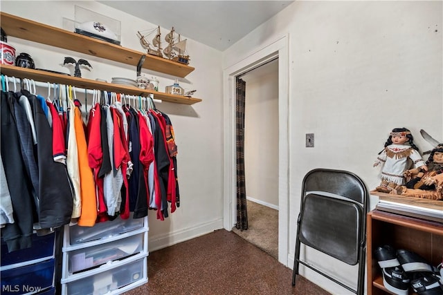 spacious closet featuring dark carpet