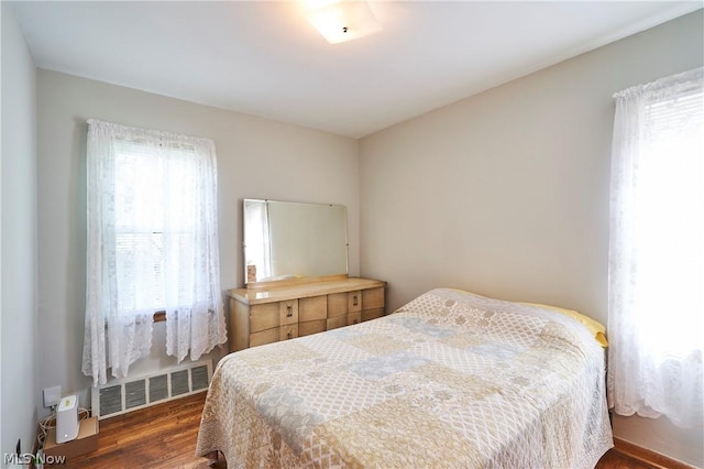 bedroom featuring dark hardwood / wood-style flooring