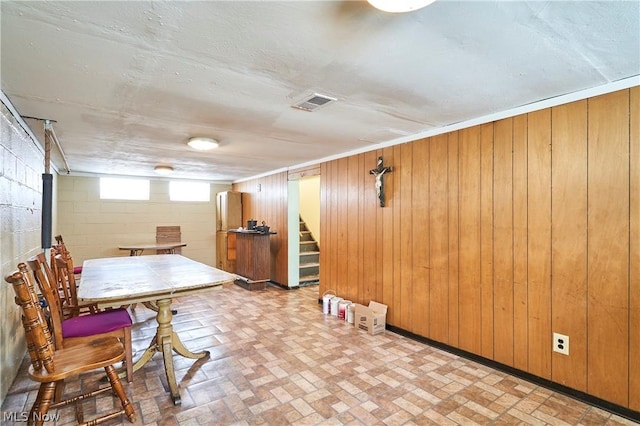 basement featuring wood walls